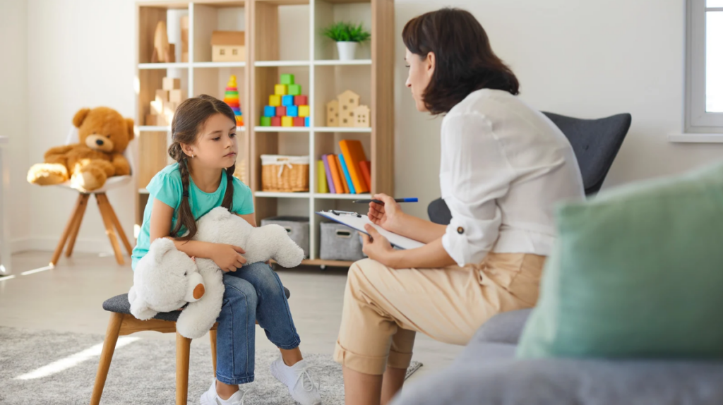 a young girl is carefully evaluated by a speech therapist