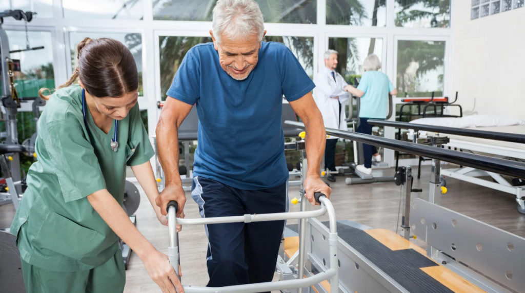 elderly man using a walker with the help of an occupational therapist