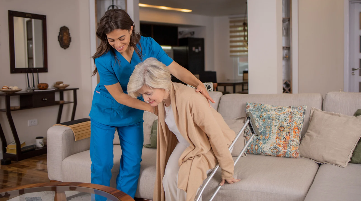 skilled nurse helping an elderly woman in getting up